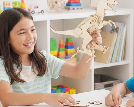 Two children building the Mechanical T-Rex and the Balancing Robot at a table
