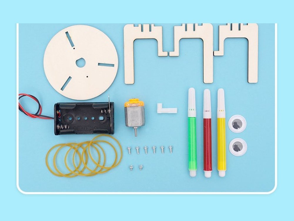 Every part in the Doodle Robot kit laid out: disc, legs, motor, crank, battery box, markers, rubber bands, googly eyes and screws
