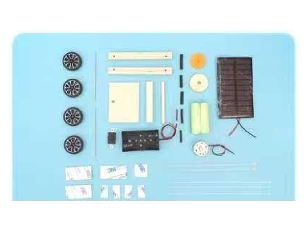 The Solar Power Car kit as supplied, with wheels, timber, the panel, motor, gear, switch and the two rechargeable cells